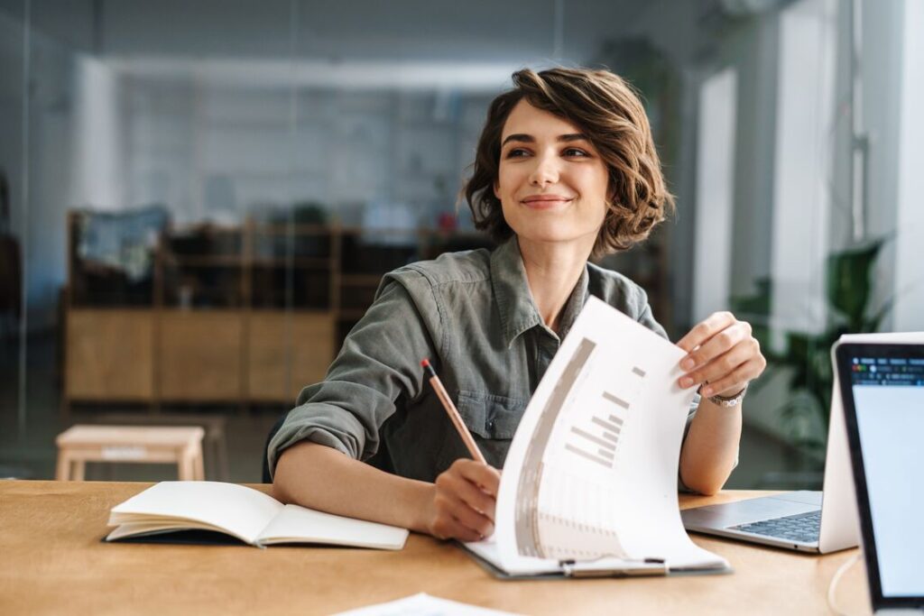 beautiful woman writing down notes